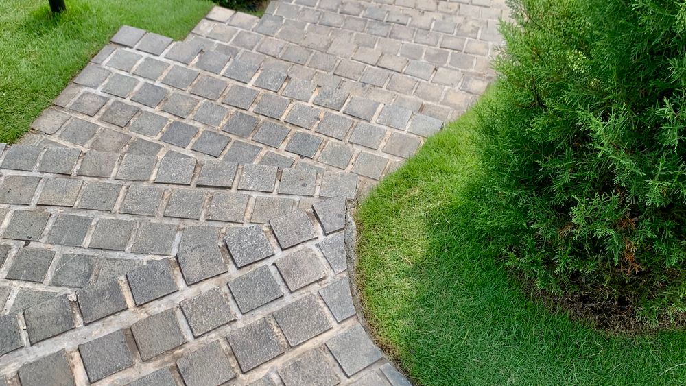 Paver walkway curving through a lawn
