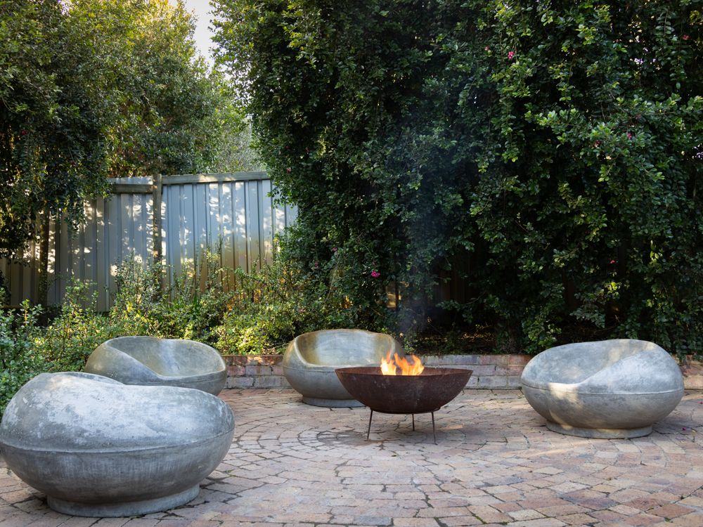 Fire feature set into a gravel court